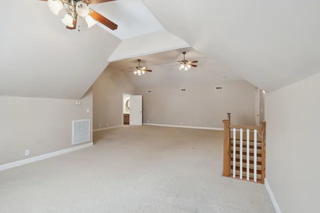 a view of an empty room with a ceiling fan