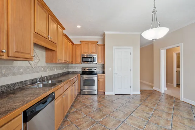 a kitchen with stainless steel appliances granite countertop a sink and cabinets