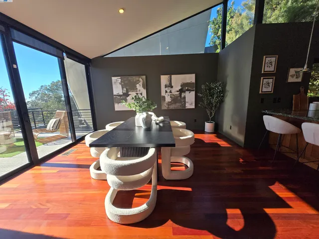 a dining room with furniture and wooden floor