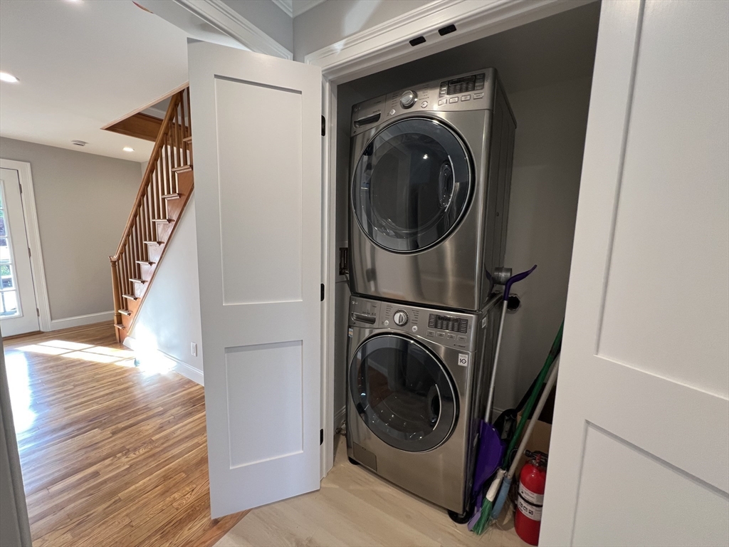 21 Brownville Avenue Ipswich, MA 01938 - Photo 11 of 20 a utility room with wooden floor and dryer