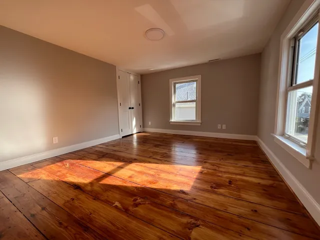 a view of room with wooden floor