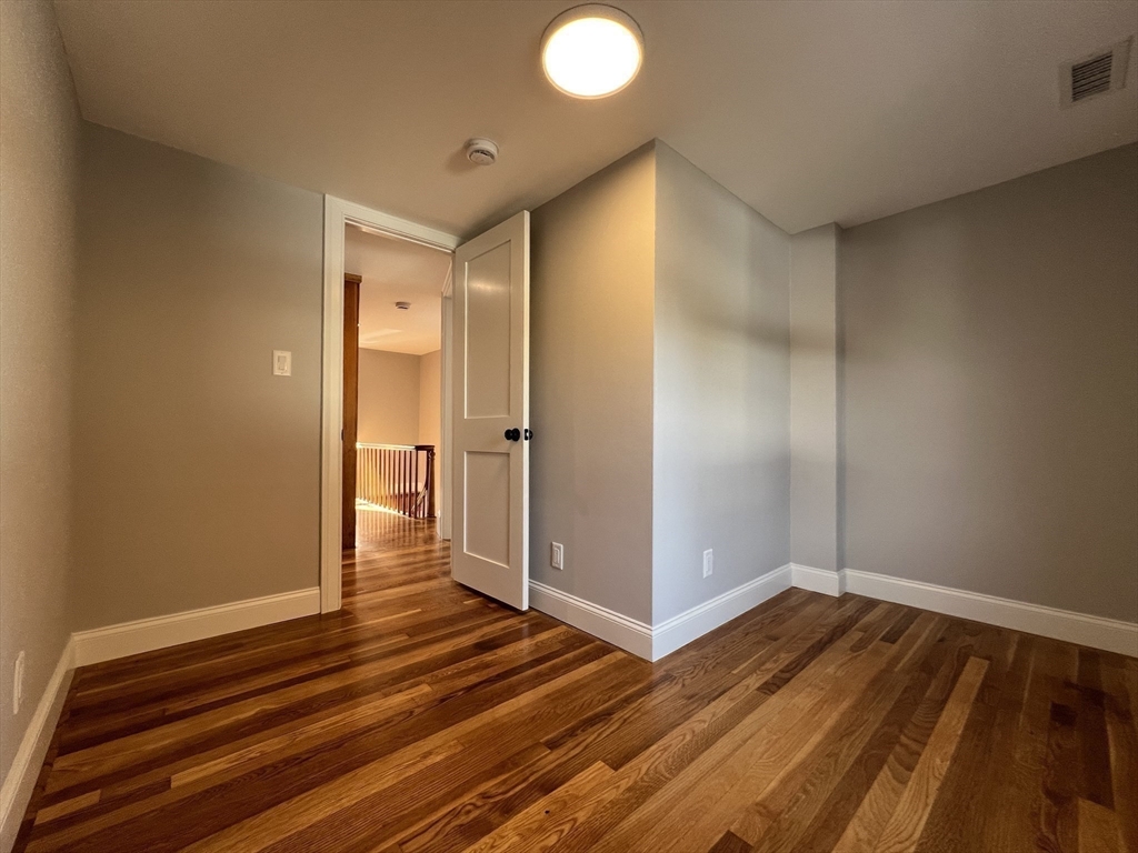 21 Brownville Avenue Ipswich, MA 01938 - Photo 15 of 20 a view of a hallway with wooden floor and closet area