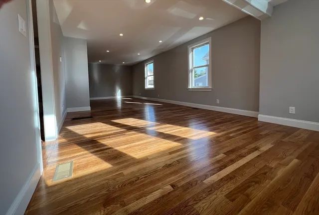 a bathroom with a granite countertop sink a toilet a mirror and shower