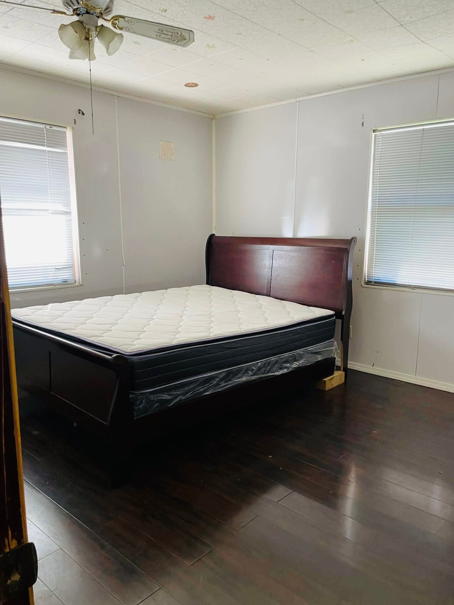 1825 Isom Street Houston, TX 77039 - Photo 18 of 27 a bedroom with a bed and a chandelier