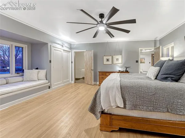 a bedroom with a large bed and a chandelier