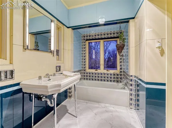 a bath room with a table and a chair