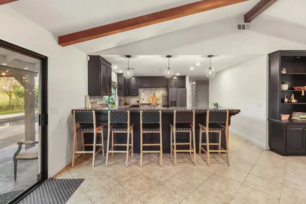 a kitchen with stainless steel appliances granite countertop a stove and a refrigerator