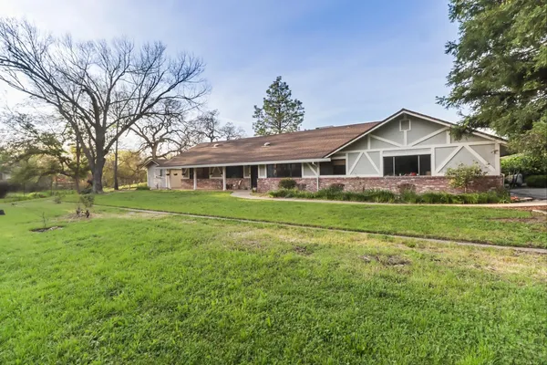 a front view of house with yard and green space