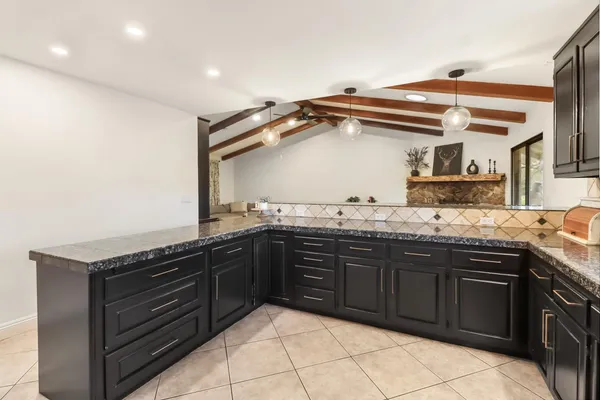 a bathroom with a granite countertop double vanity sink and a mirror