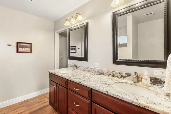 a bathroom with a granite countertop sink toilet and shower