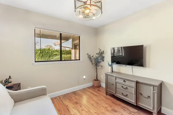 a living room with furniture and a wooden floor