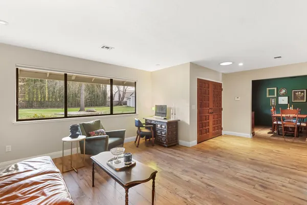 a dining room with furniture and a window