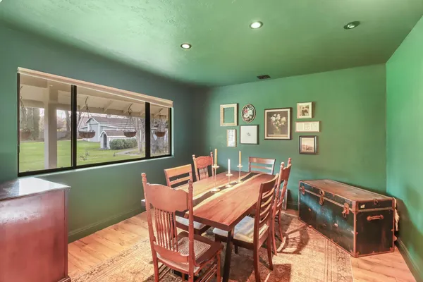 a dining room with furniture and a window