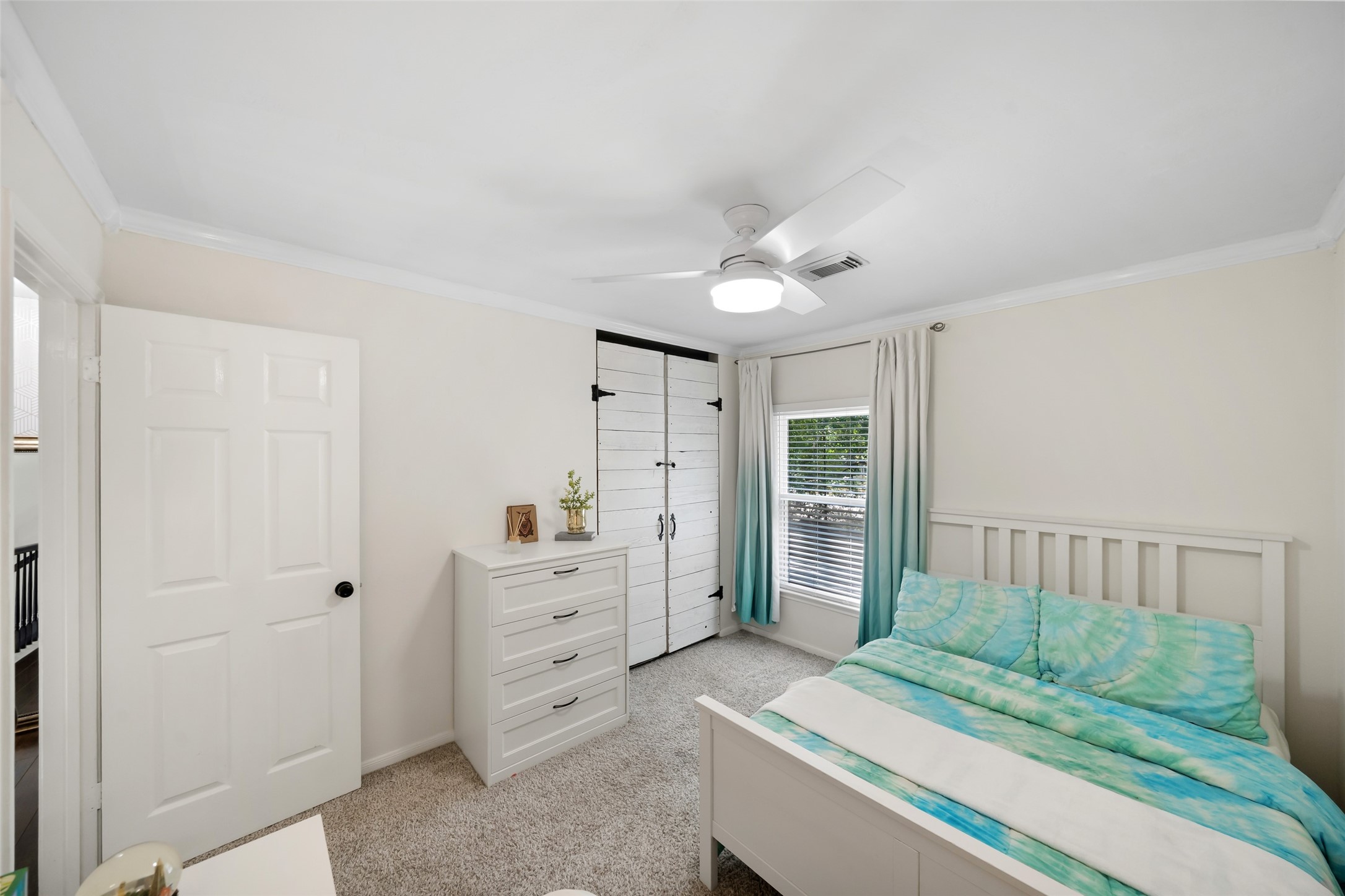 3 East Stony Bridge Circle Spring, TX 77381 - Photo 31 of 42 This upper-level secondary bedroom features neutral walls, carpeting, and a modern ceiling fan. A large window provides natural light, and the layout includes a dedicated closet for storage.