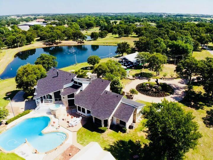 an aerial view of house with yard swimming pool and outdoor seating