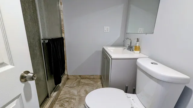 a bathroom with a sink a toilet and shower