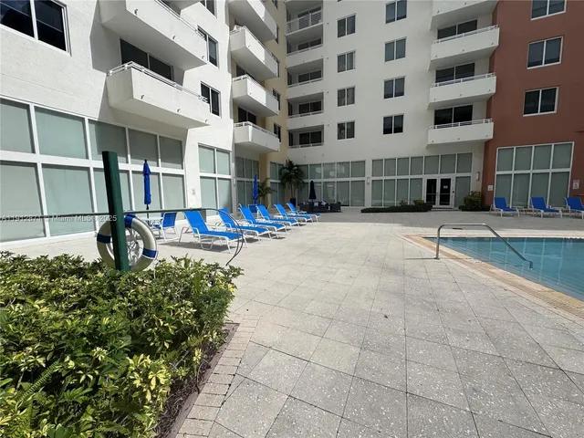 a front view of a building with a garden