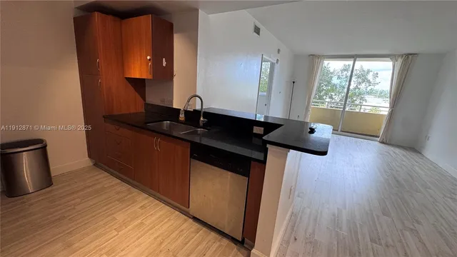 a living room with wooden floor and large window