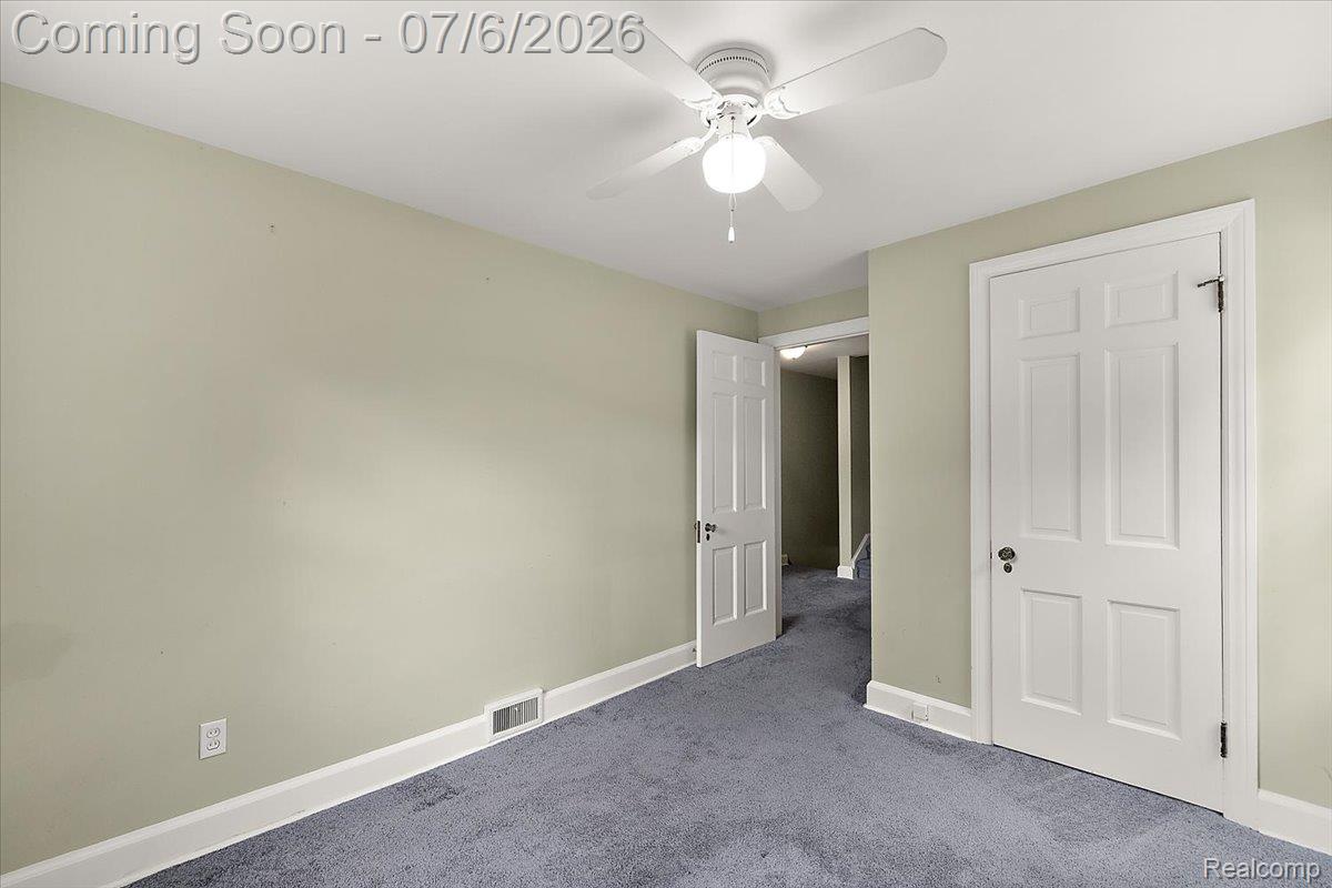 1051 Devonshire Road Grosse Pointe, MI 48230 - Photo 42 of 98 Room with muted green walls and blue carpeting