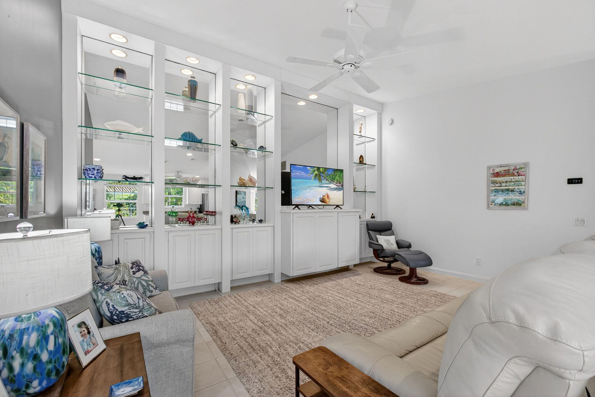 1035 Southwest Tamarrow Place Stuart, FL 34997 - Photo 13 of 42 a bed room with furniture and a chandelier