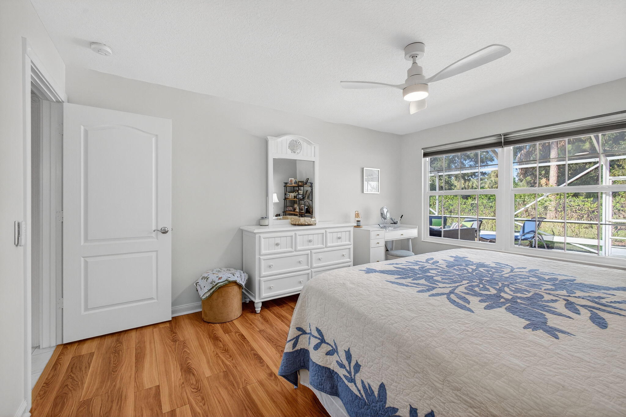 1035 Southwest Tamarrow Place Stuart, FL 34997 - Photo 19 of 42 a bedroom with a bed and a window