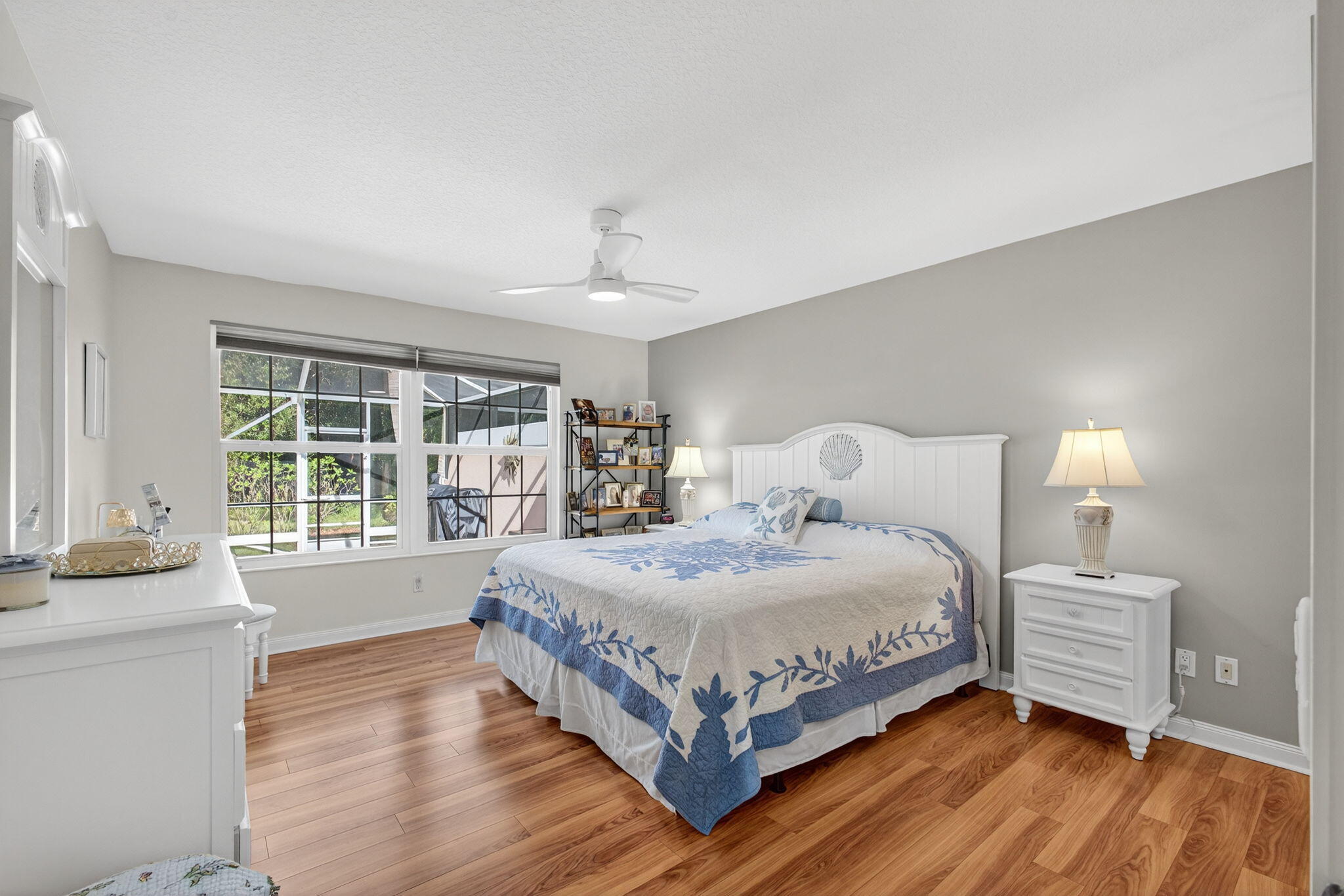 1035 Southwest Tamarrow Place Stuart, FL 34997 - Photo 20 of 42 a bedroom with a large bed and a large window