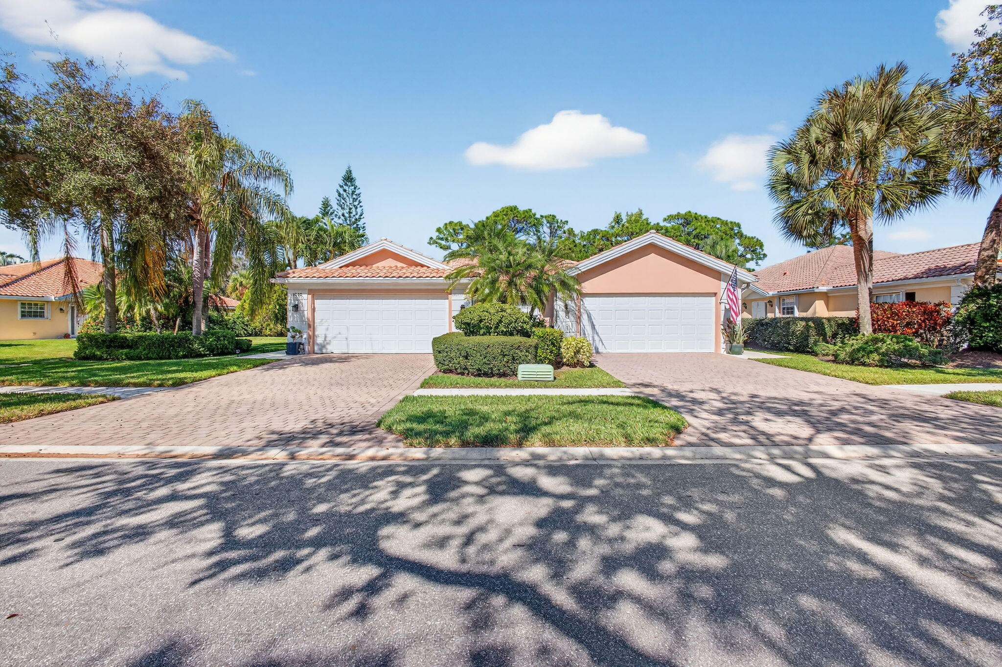 1035 Southwest Tamarrow Place Stuart, FL 34997 - Photo 2 of 42 a front view of a house with a yard and garage