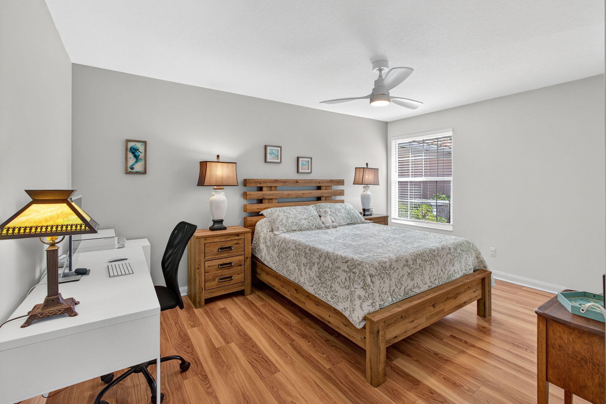 1035 Southwest Tamarrow Place Stuart, FL 34997 - Photo 23 of 42 a bedroom with a bed and a table in it