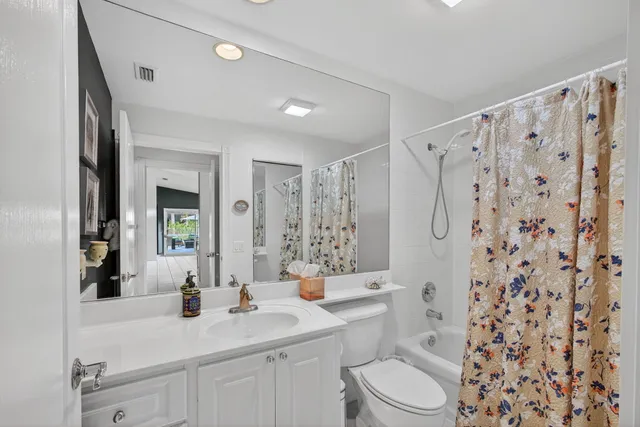 a utility room with cabinets washer and dryer