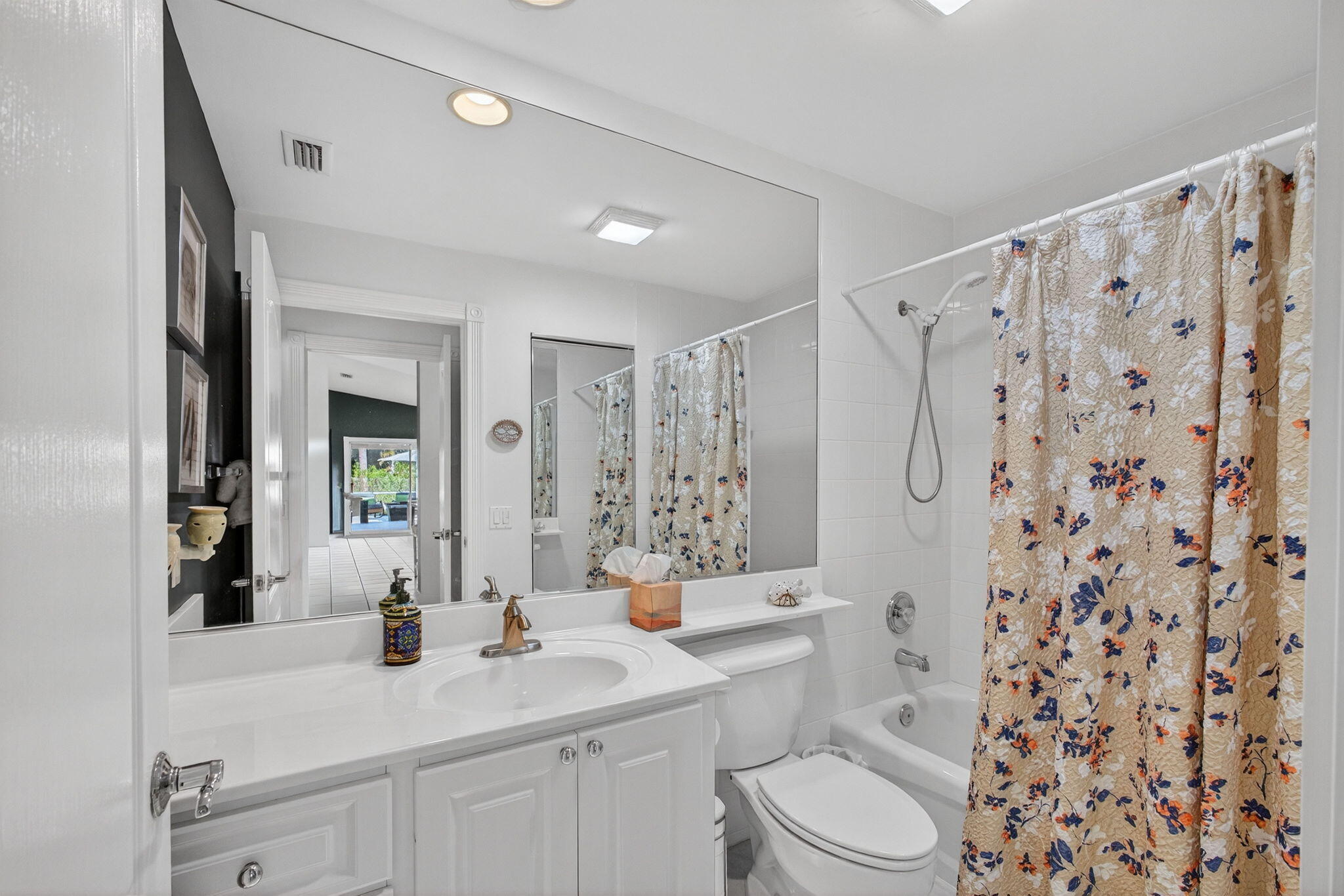 1035 Southwest Tamarrow Place Stuart, FL 34997 - Photo 24 of 42 a bathroom with a sink a toilet a mirror a vanity and shower