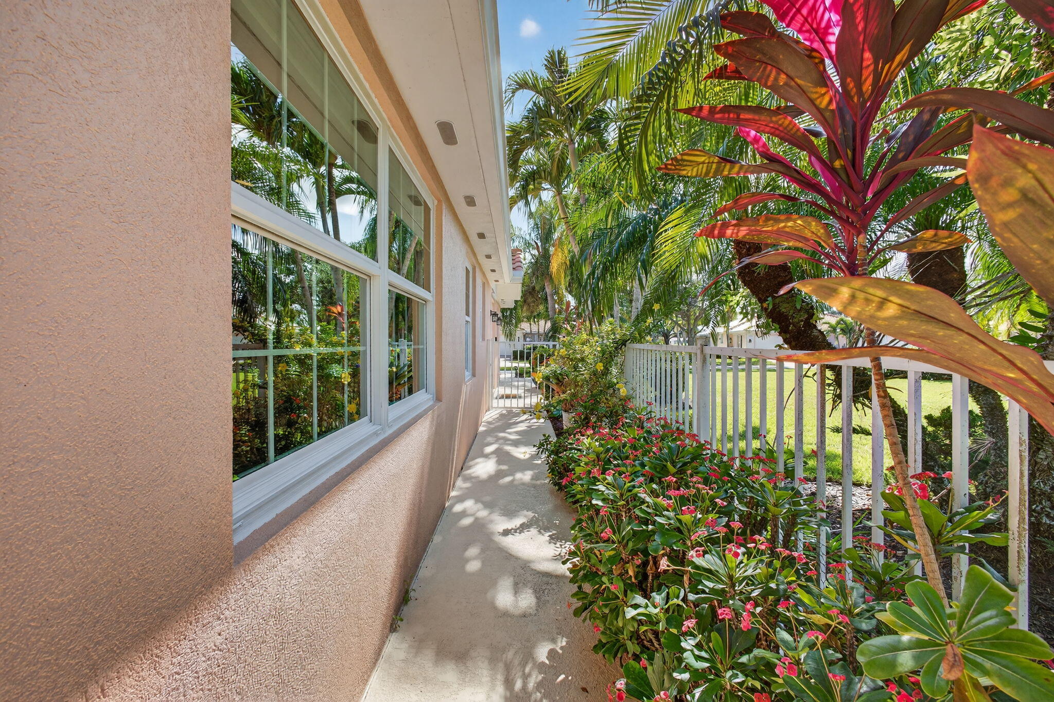 1035 Southwest Tamarrow Place Stuart, FL 34997 - Photo 36 of 42 a picture of flowers in front of a glass door