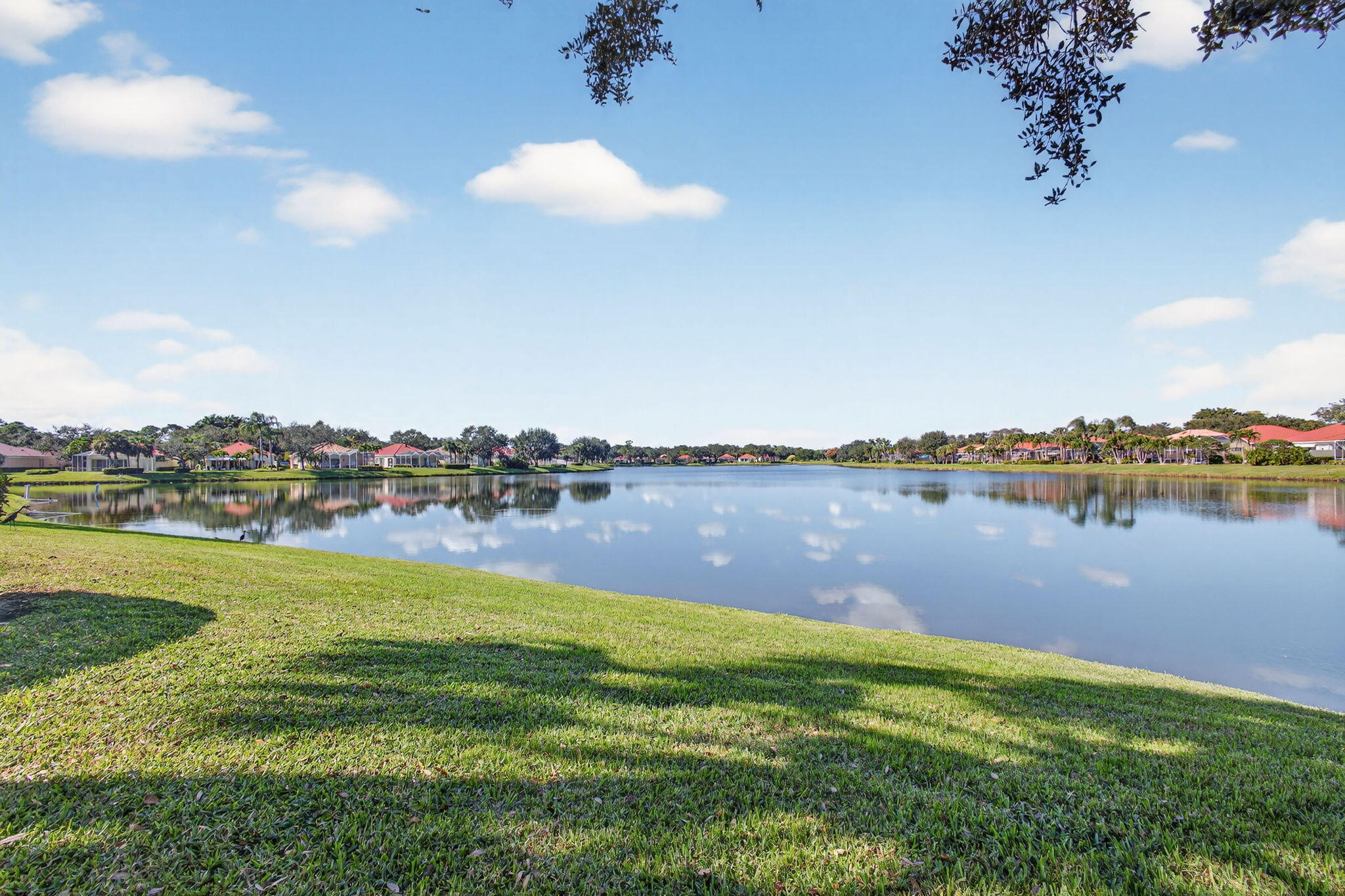 1035 Southwest Tamarrow Place Stuart, FL 34997 - Photo 41 of 42 a view of a lake with houses in the back