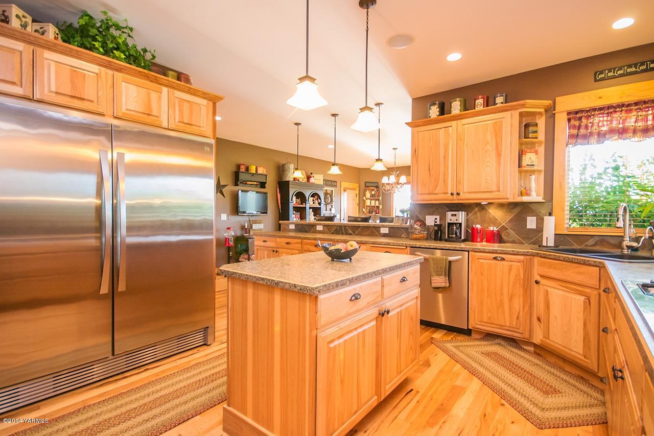 1292 Deeringhoff Road Moxee, WA 98936 - Photo 13 of 42 a kitchen with stainless steel appliances granite countertop a sink a stove and a refrigerator