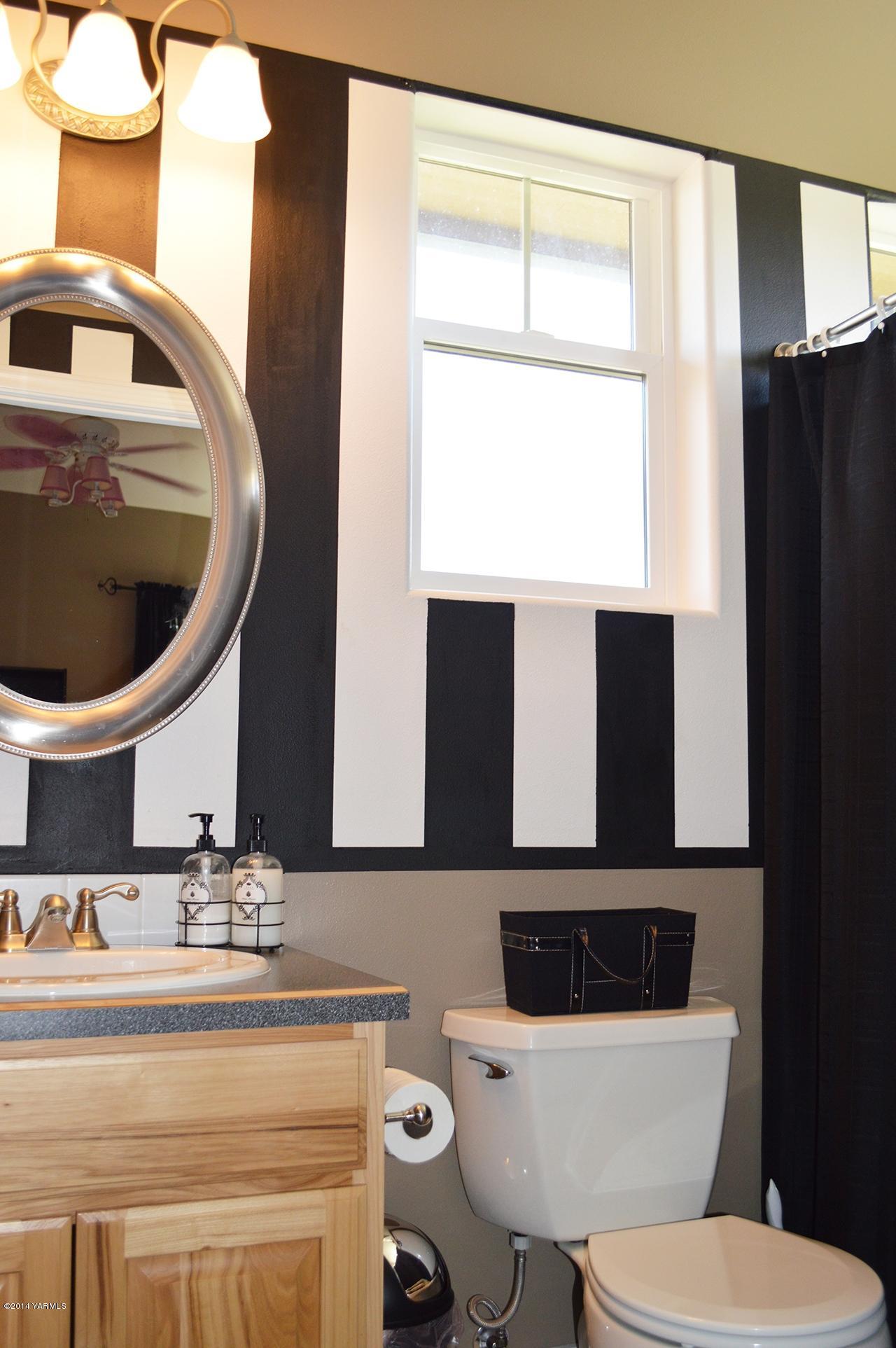 1292 Deeringhoff Road Moxee, WA 98936 - Photo 29 of 42 a bathroom with a sink a toilet and mirror