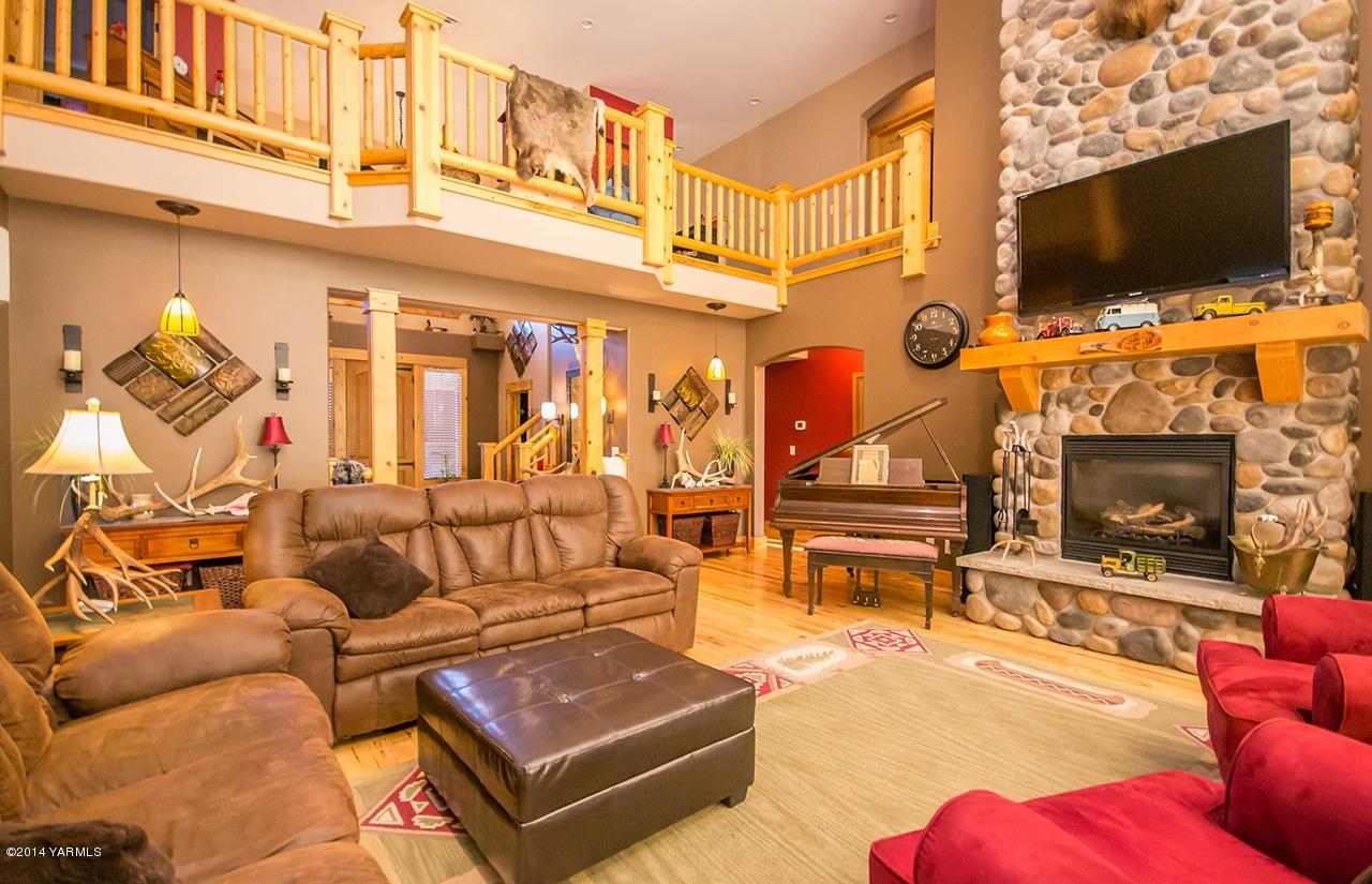 1292 Deeringhoff Road Moxee, WA 98936 - Photo 8 of 42 a living room with furniture a flat screen tv and a fireplace