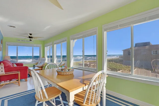 a dining room with furniture a chandelier and window