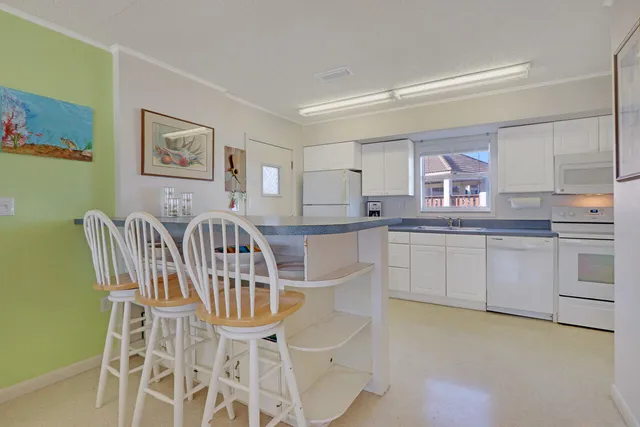 a kitchen with cabinets and chairs