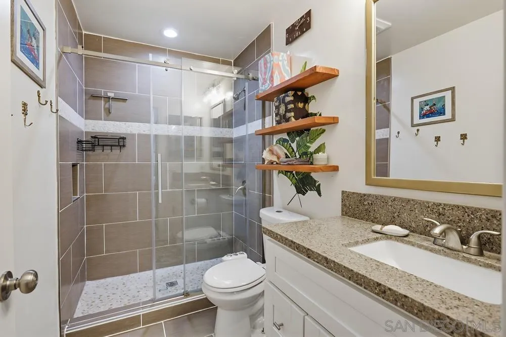 712 Lemon Avenue Vista, CA 92084 - Photo 16 of 29 a bathroom with a sink a toilet and shower