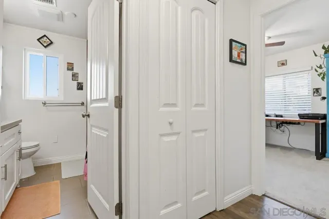 a bathroom with a granite countertop sink a toilet and a shower