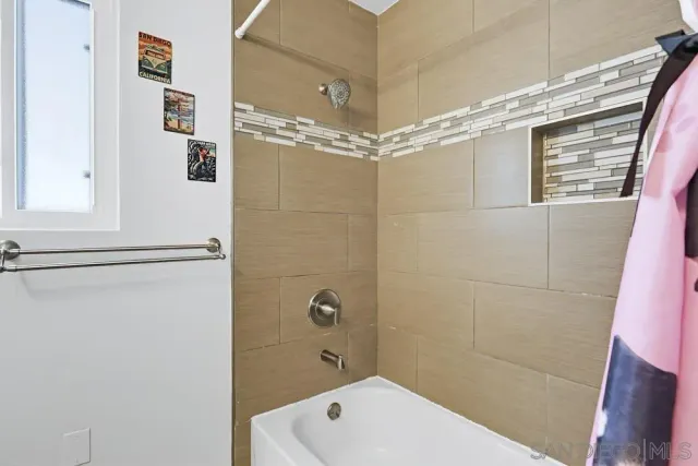 a bathroom with a shower and a sink