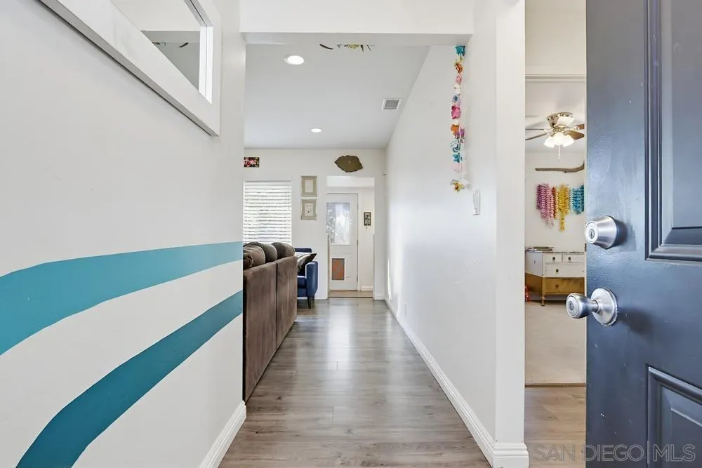 712 Lemon Avenue Vista, CA 92084 - Photo 28 of 29 a view of hallway with furniture and a wooden floor