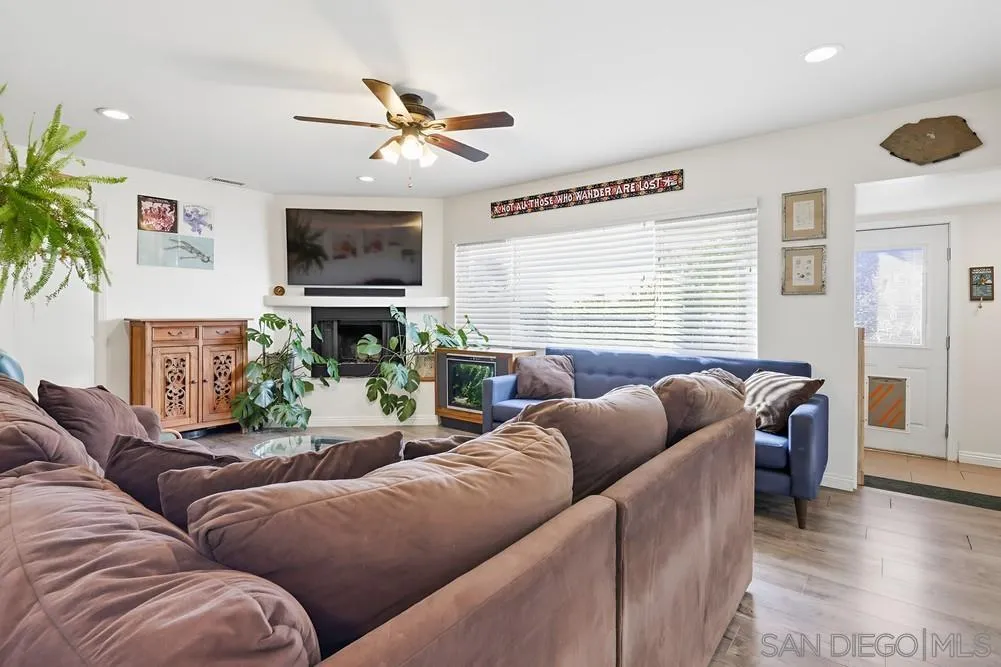 712 Lemon Avenue Vista, CA 92084 - Photo 8 of 29 a living room with furniture a fireplace and a flat screen tv