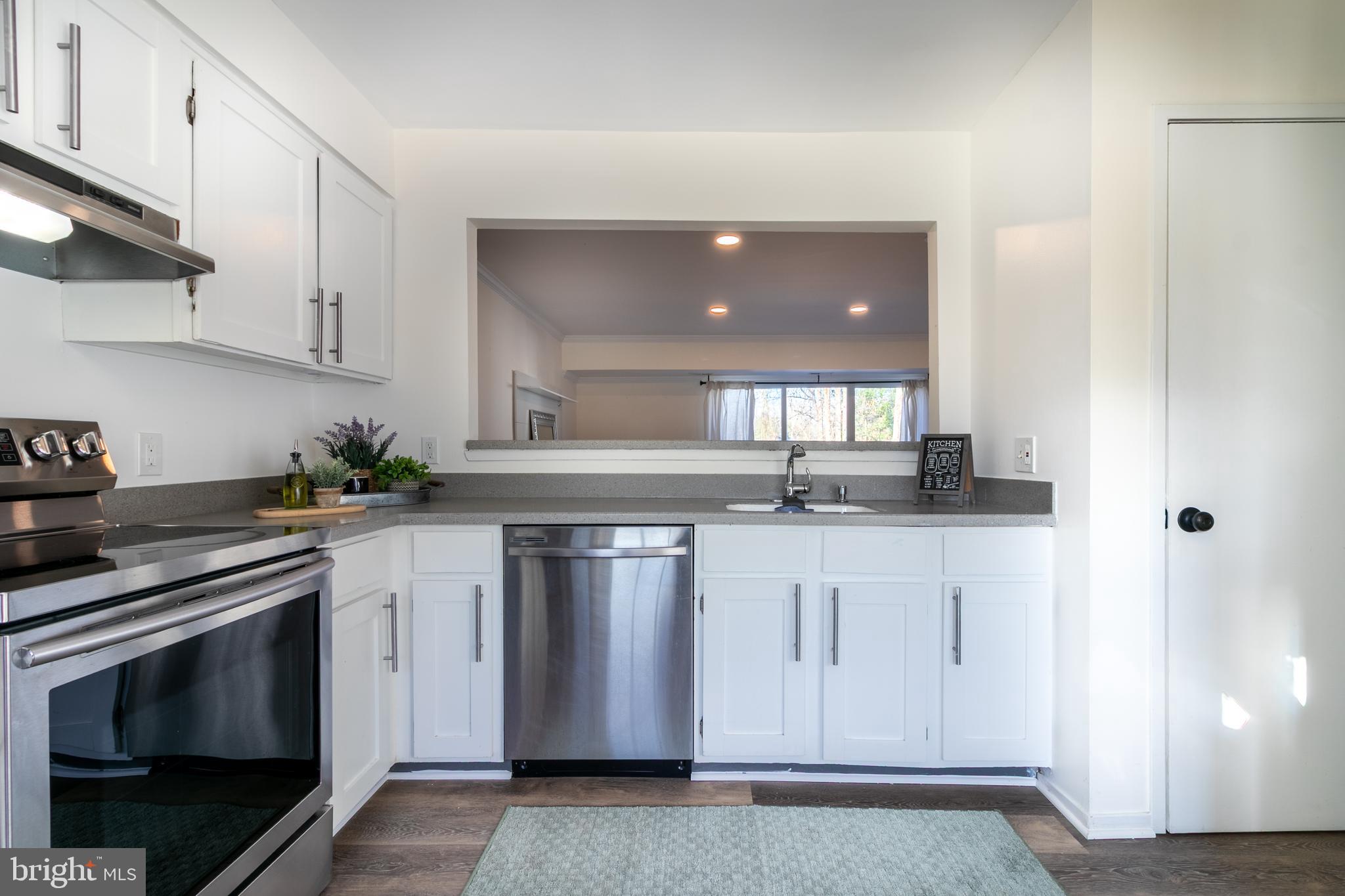 17411 Pipers Way, Unit 7 Olney, MD 20832 - Photo 11 of 22 a kitchen with stainless steel appliances granite countertop a stove a sink and a refrigerator