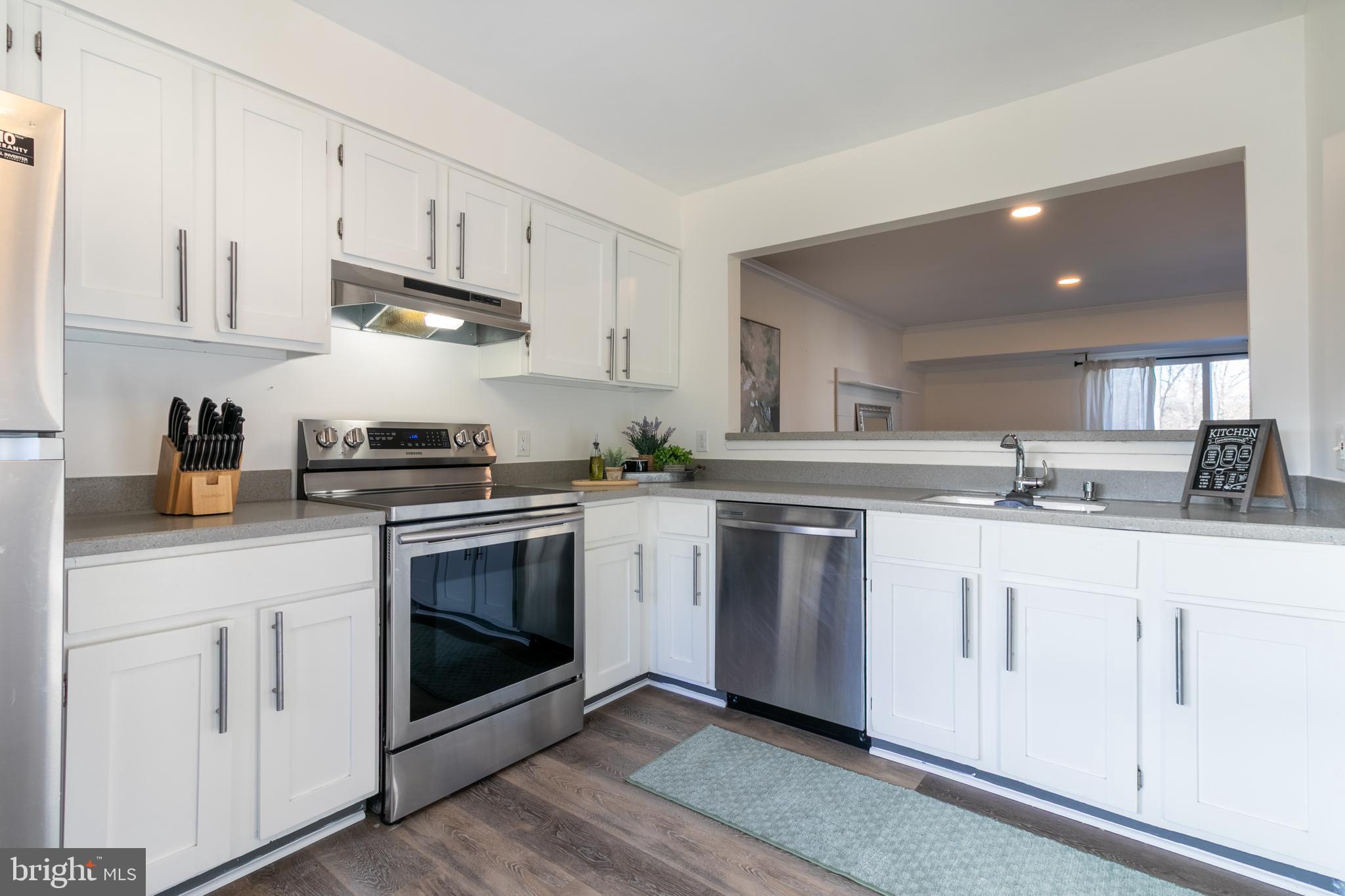 17411 Pipers Way, Unit 7 Olney, MD 20832 - Photo 10 of 22 a kitchen with granite countertop white cabinets and white appliances