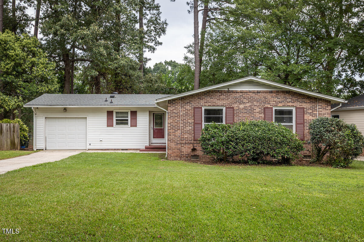 4912 Auburn Road Raleigh, NC 27609 - Photo 1 of 23 a front view of a house with a yard and garage