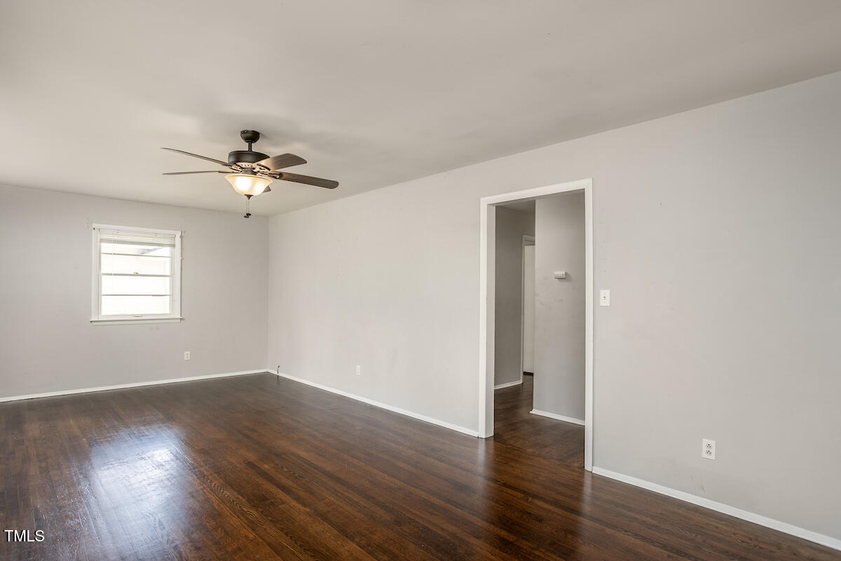 4912 Auburn Road Raleigh, NC 27609 - Photo 11 of 23 a view of a room with wooden floor and chandelier fan