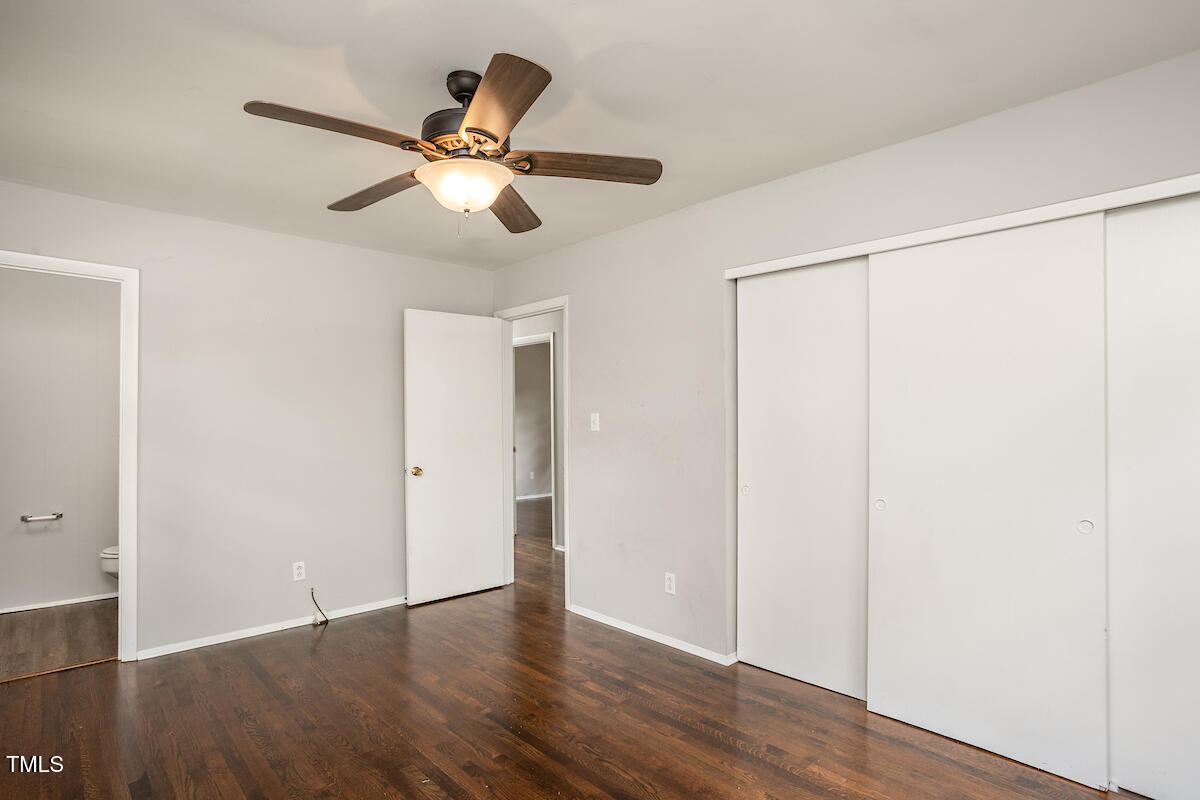 4912 Auburn Road Raleigh, NC 27609 - Photo 13 of 23 a view of an empty room with wooden floor