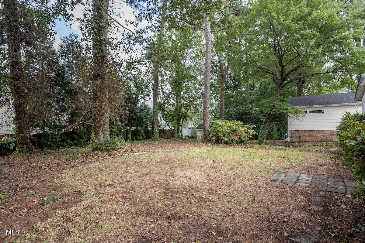4912 Auburn Road Raleigh, NC 27609 - Photo 20 of 23 a backyard of a house with trees and plants