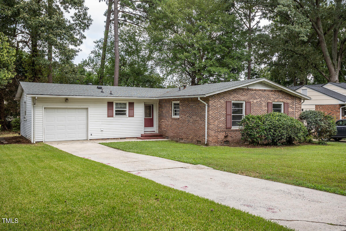 4912 Auburn Road Raleigh, NC 27609 - Photo 21 of 23 a front view of a house with a yard and garage