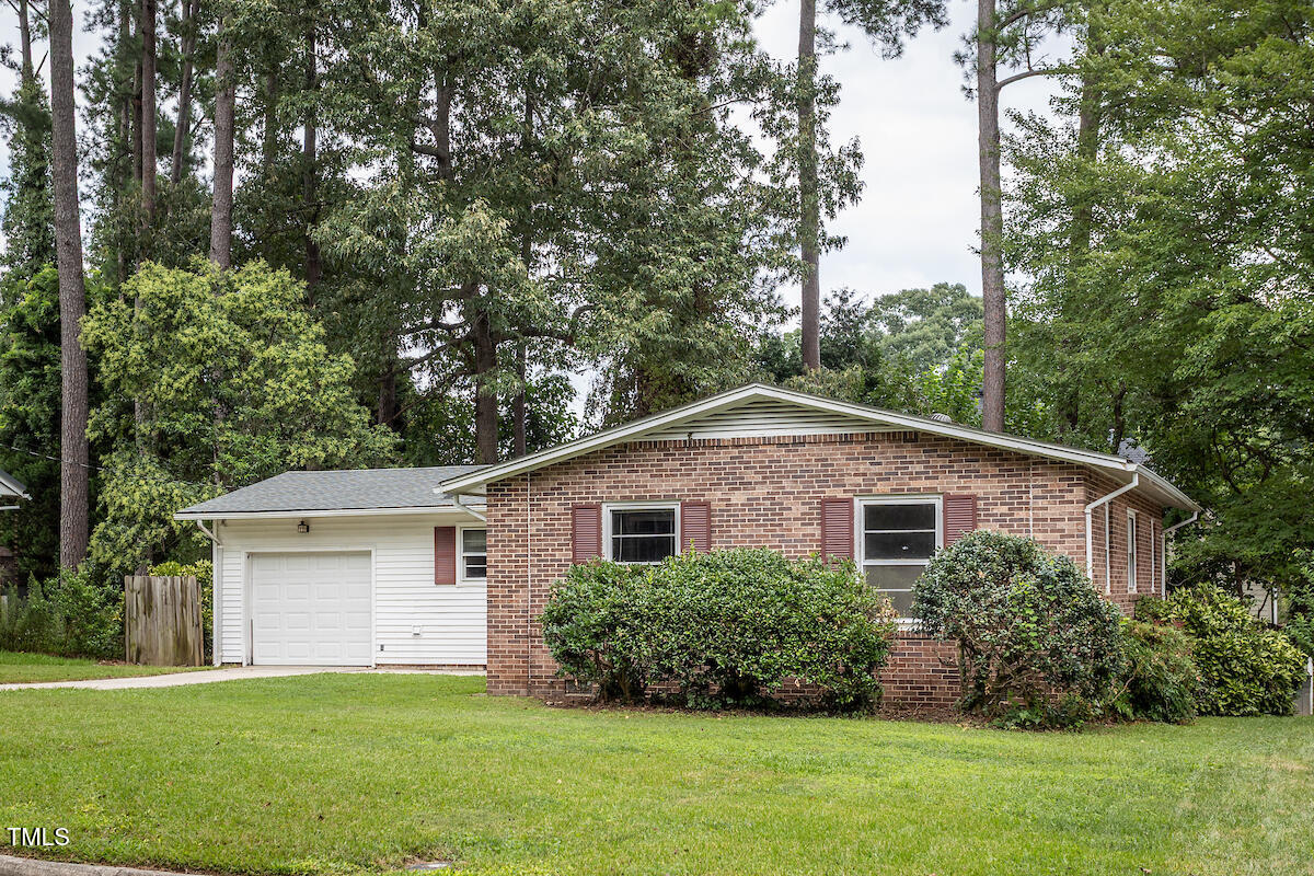 4912 Auburn Road Raleigh, NC 27609 - Photo 22 of 23 a white house that has a tree in front of it